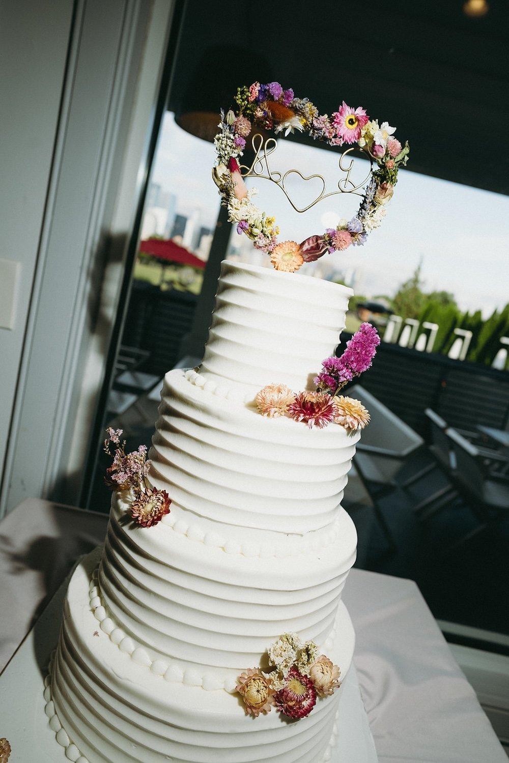 The wedding cake decorated with color florals from wedding sitting at 4 layers. 