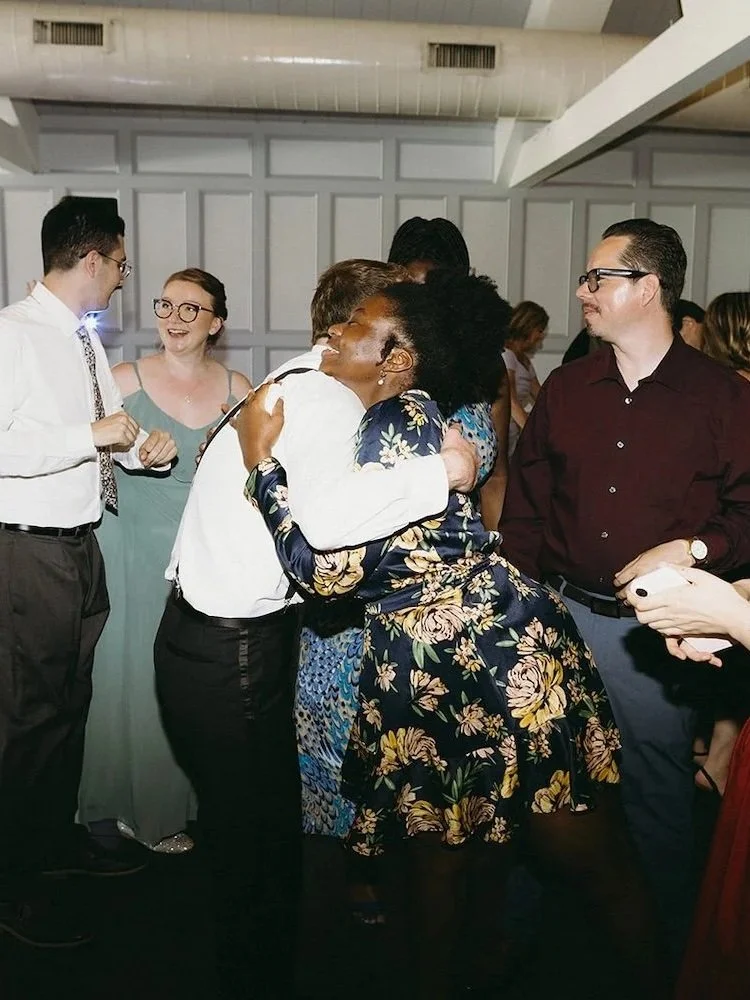 The groom hugs a guest of the wedding. 