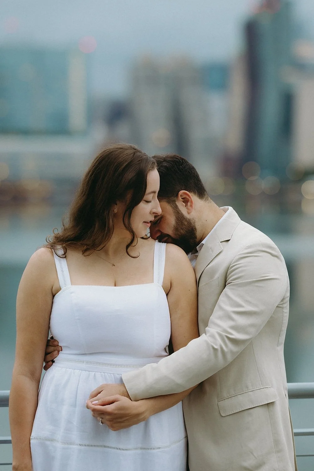 Future groom kisses the shoulder of his soon to be bride. 