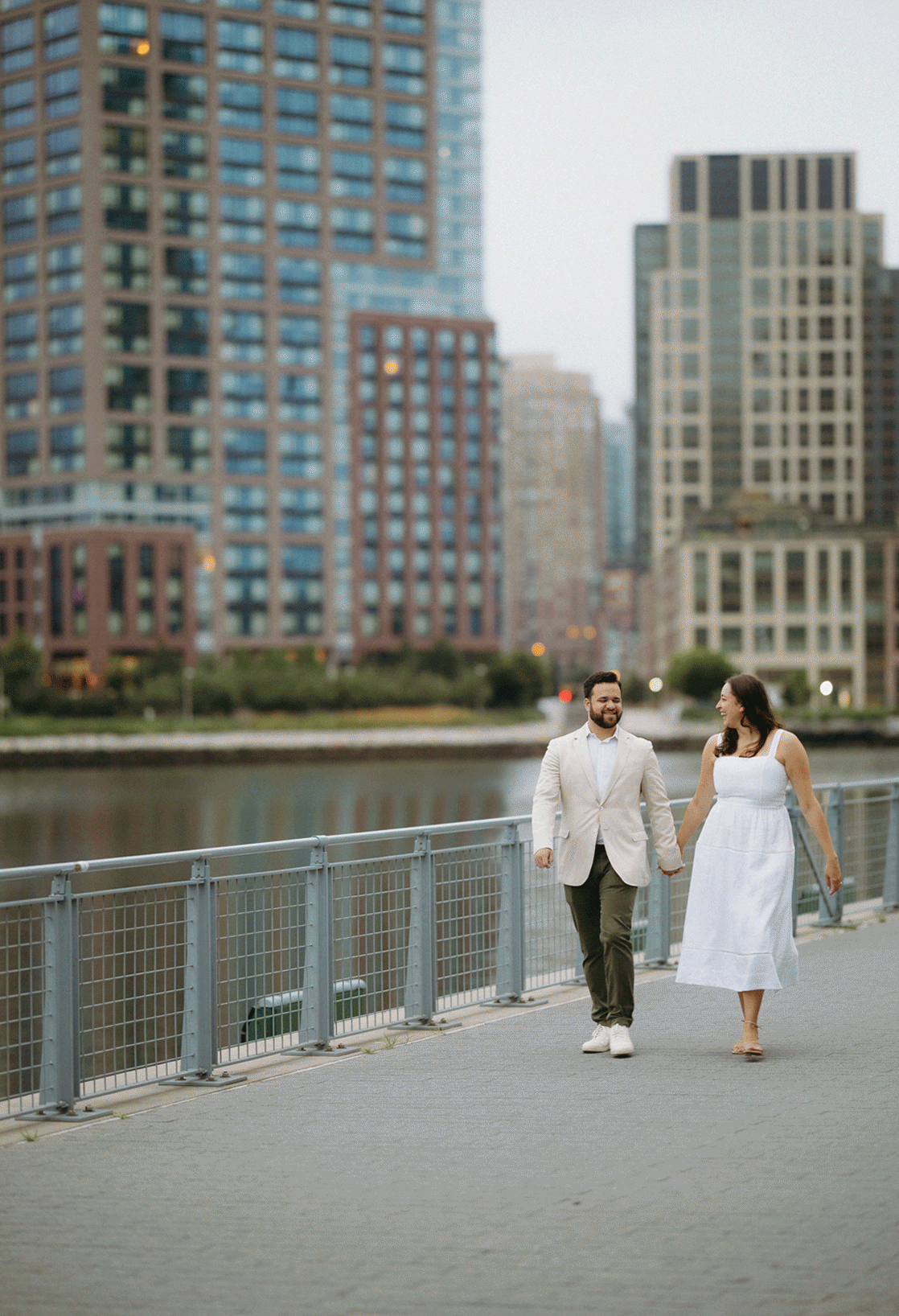 Live photo of the couple walking the waterfront path hand-in-hand.