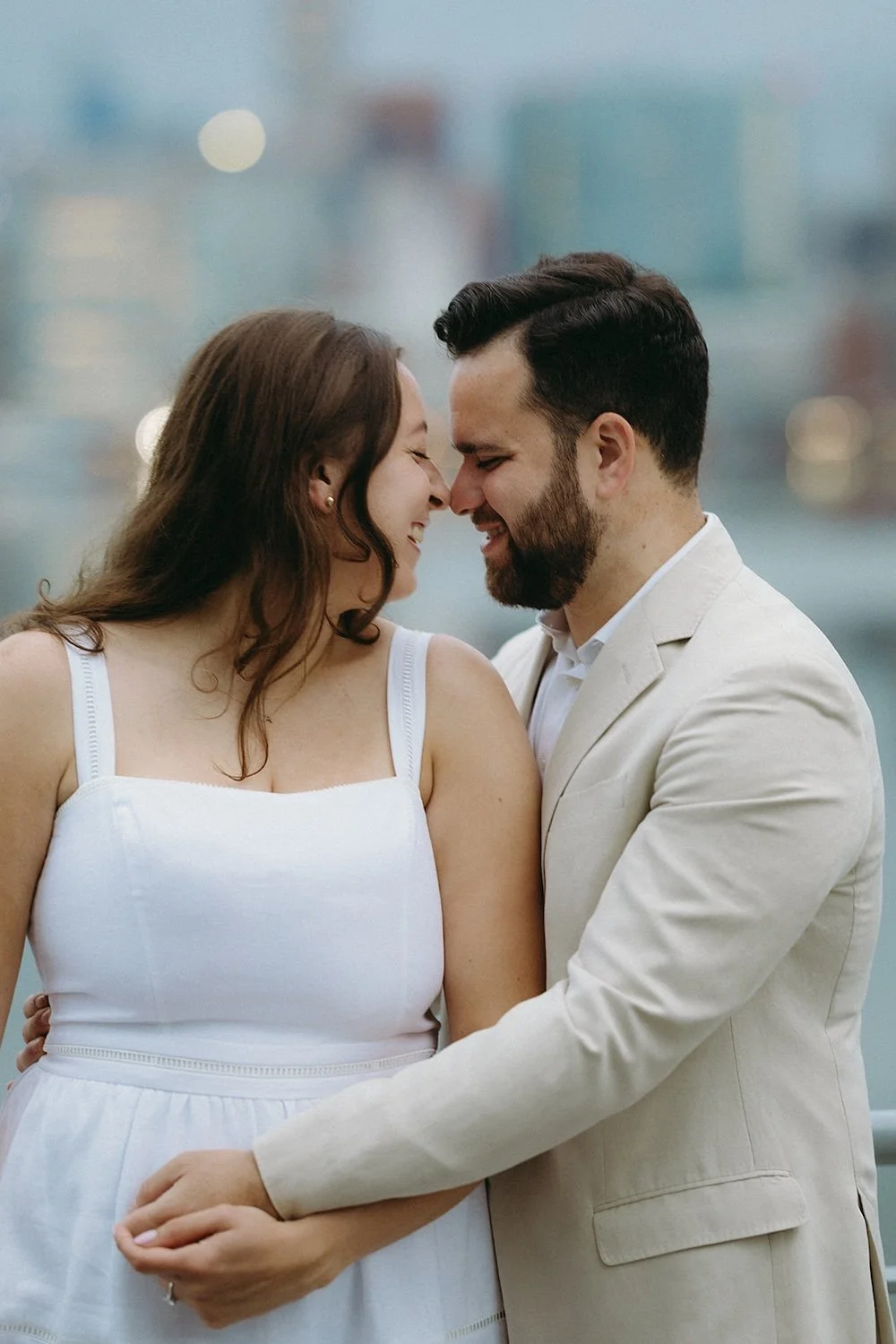 Couple share a smile while touching their noses together. 