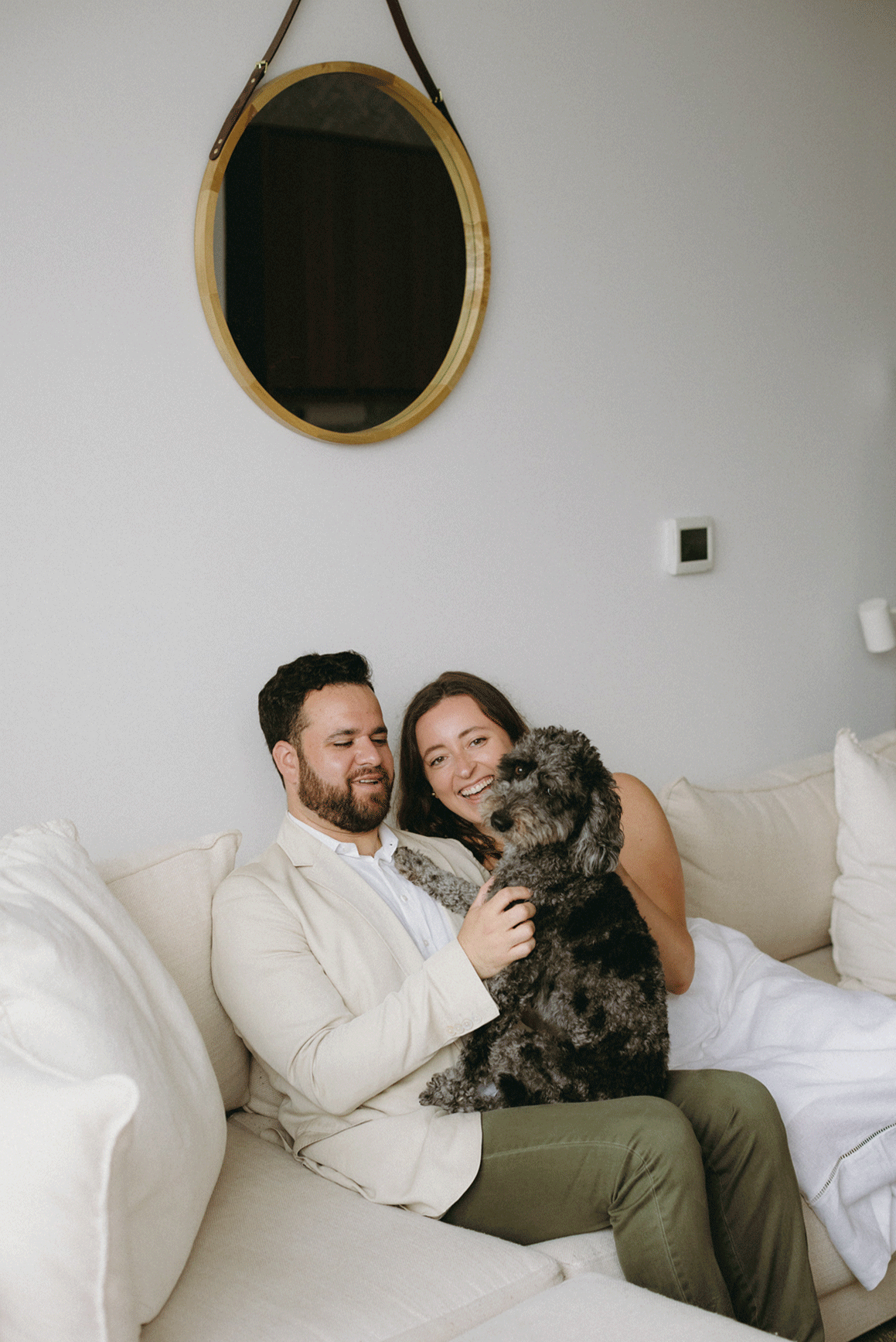 Live photo of the couple playing with their pup. 