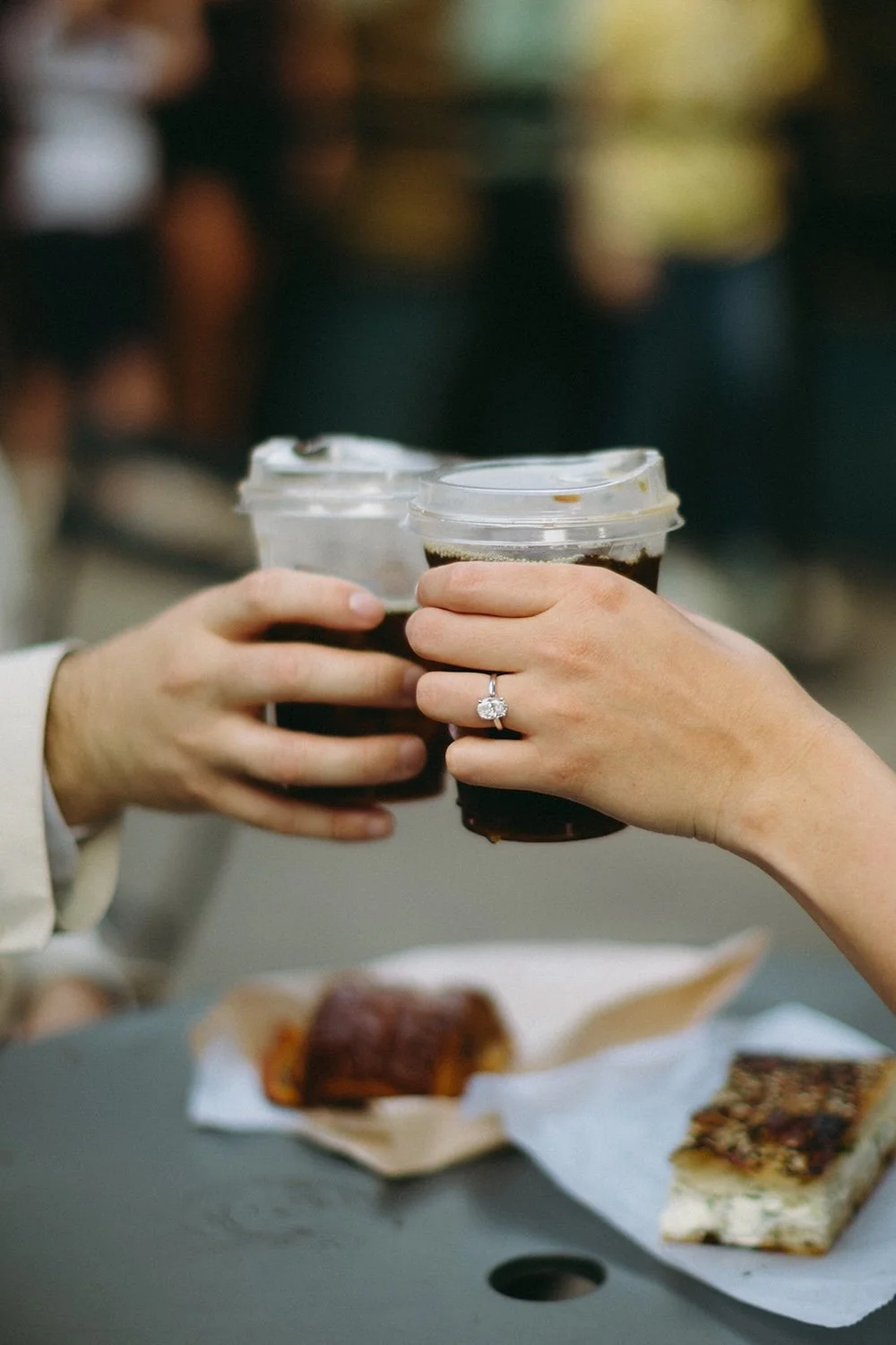 The happy couple cheers with their favorite coffees. 