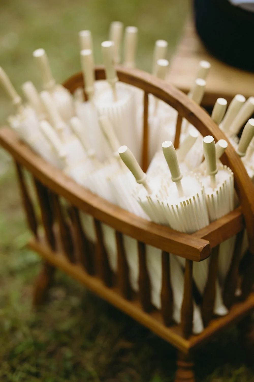 White paper umbrellas in wooden antique basket. 