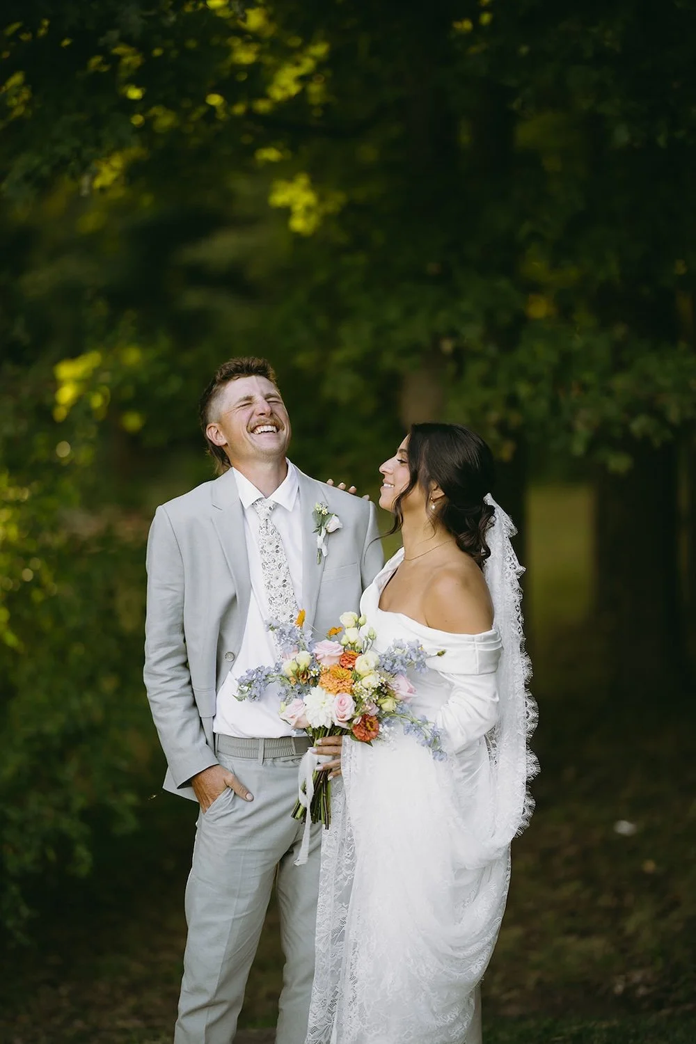 The groom shares a laugh with his bride to be. 