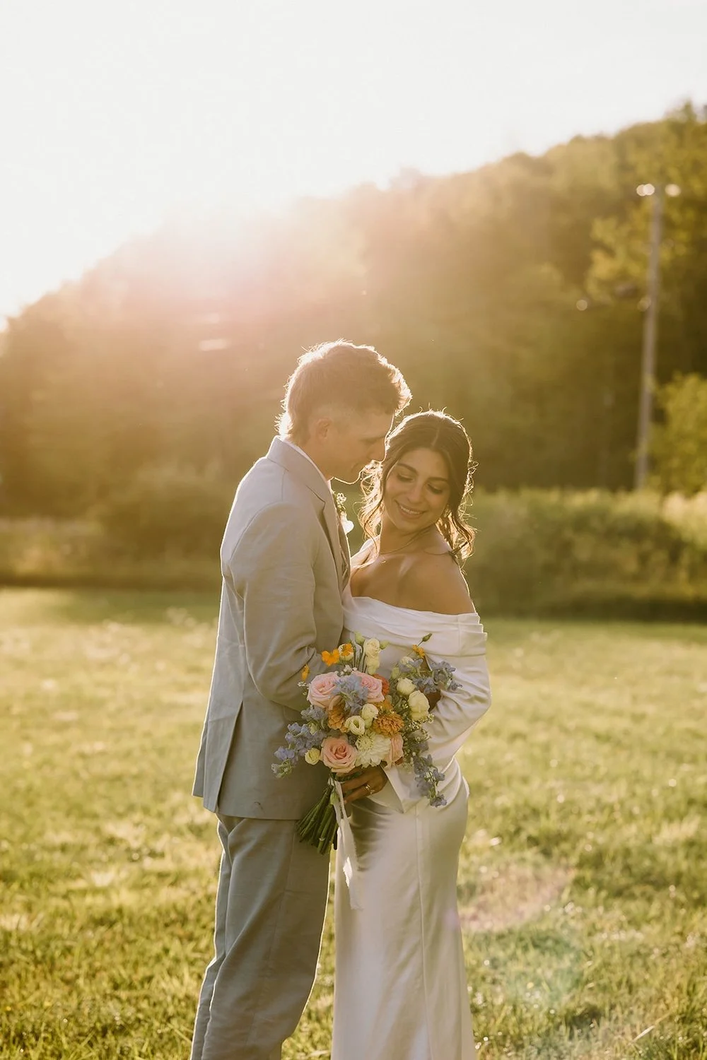 The bride and groom pose during the blue hour. 