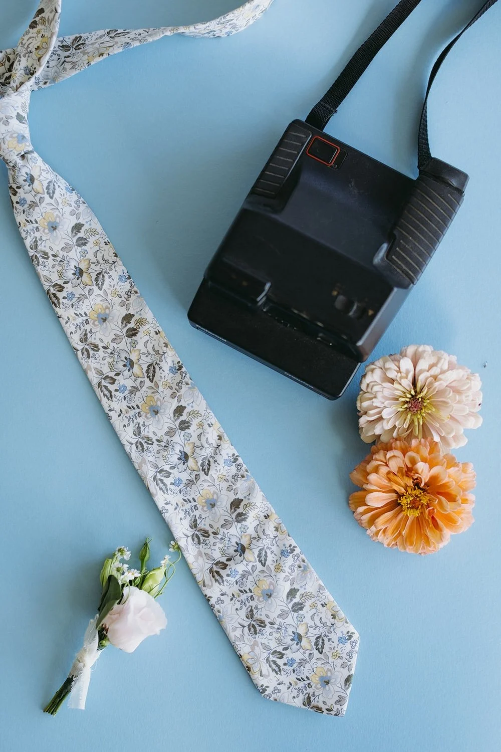 Detail photo of the grooms tie and boutonnière.. 