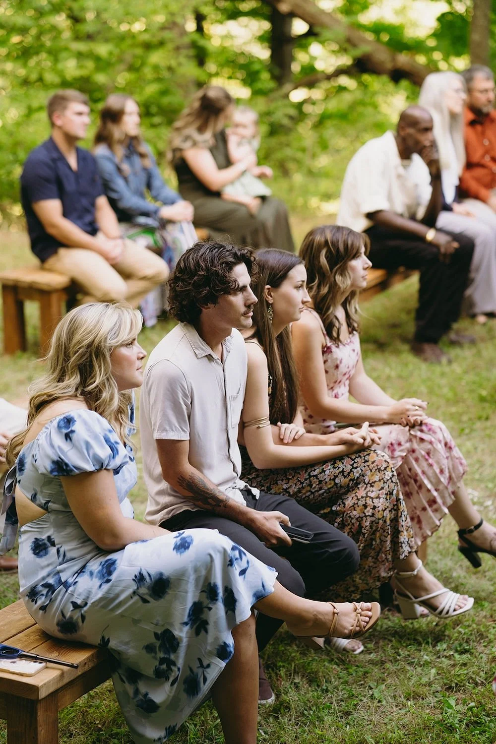 Photo of the guests sitting as the awaiting the wedding ceremony to start. 