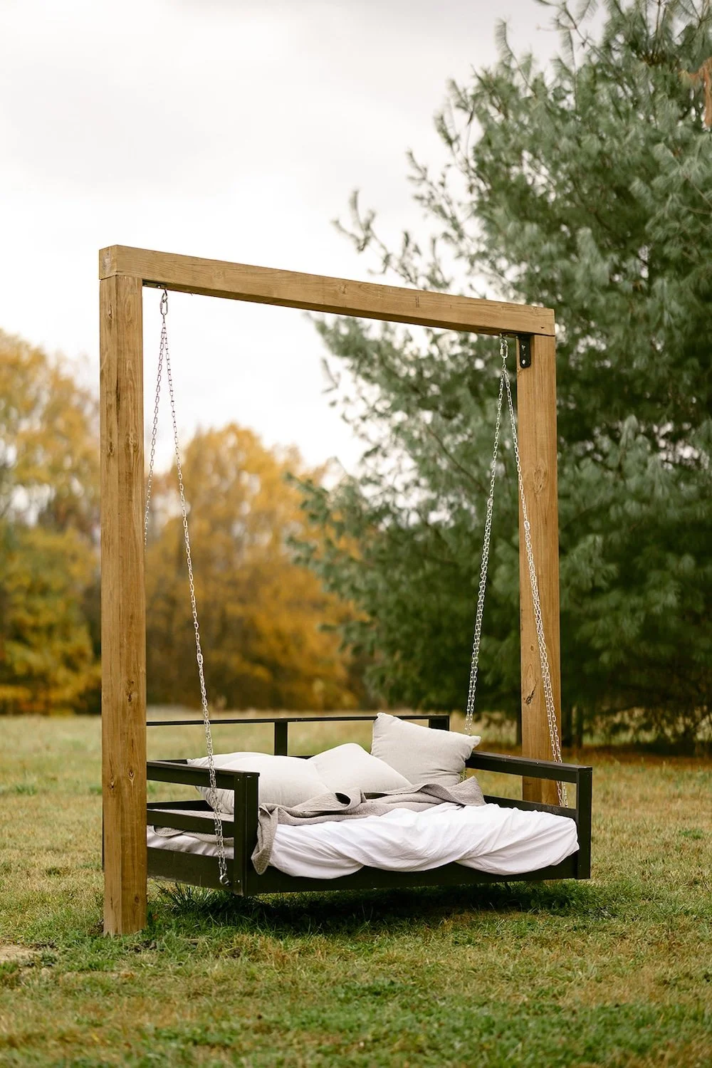 Outdoor bed swing for guests to relax and enjoy the fall air. 