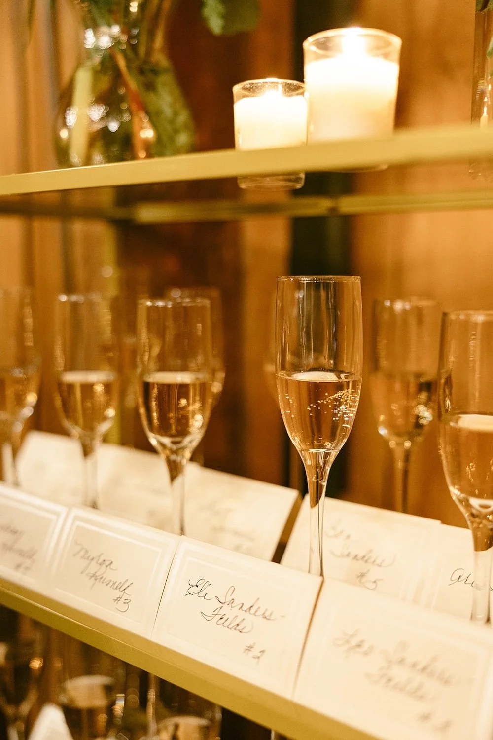 Champagne glasses with attached setting placements for each guest. 