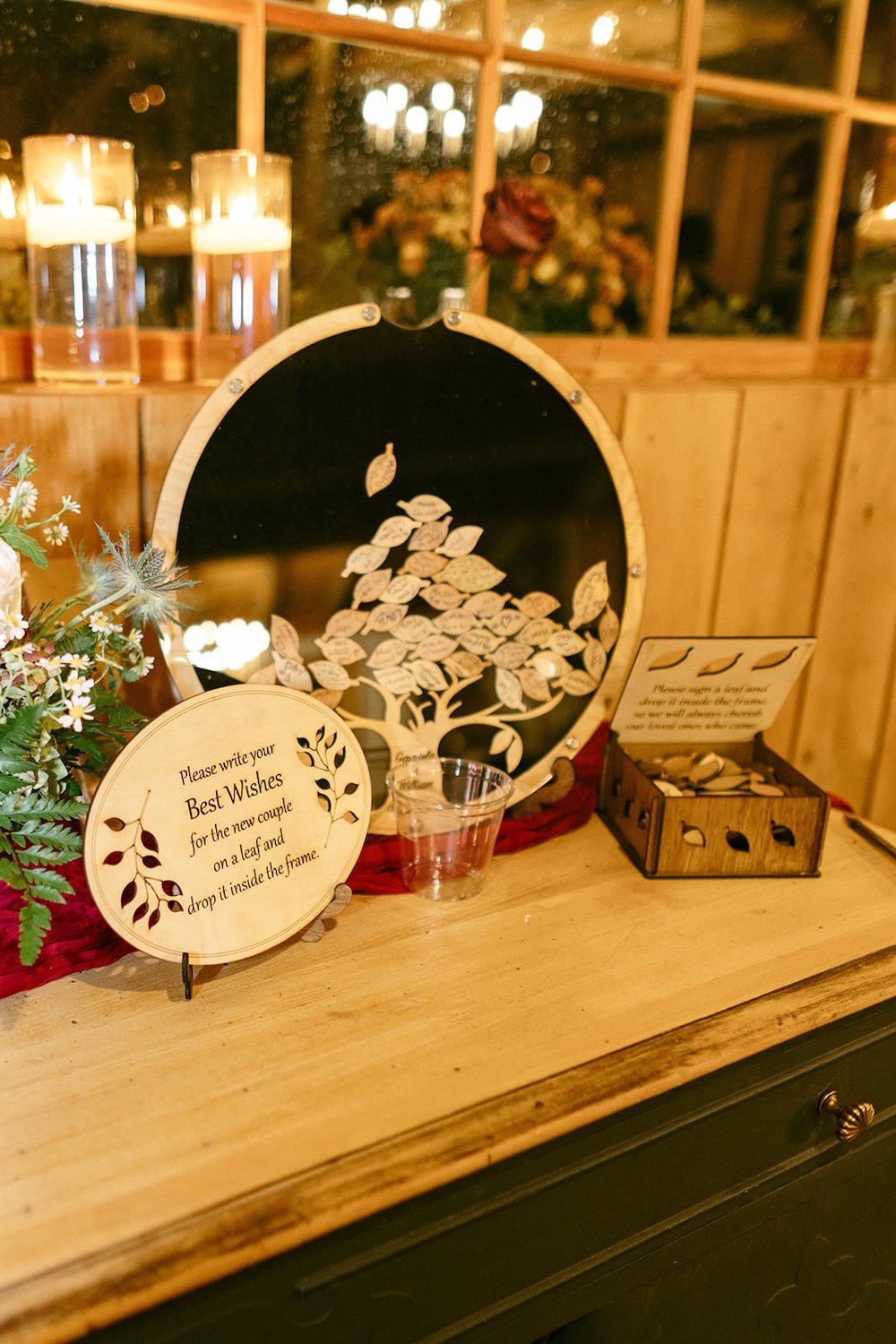 The couples wedding guest book was a family tree designed for every guest to sign a leaf and drop into the sign. 