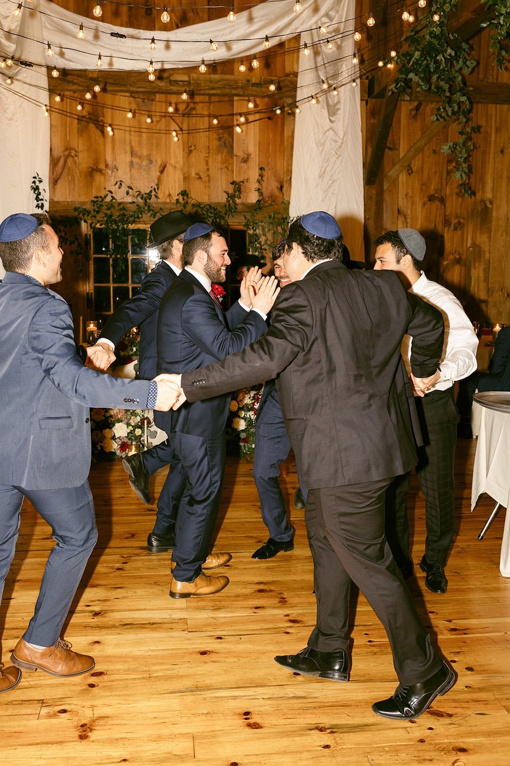 Men of the family share a traditional dance together celebrating the happy couple. 
