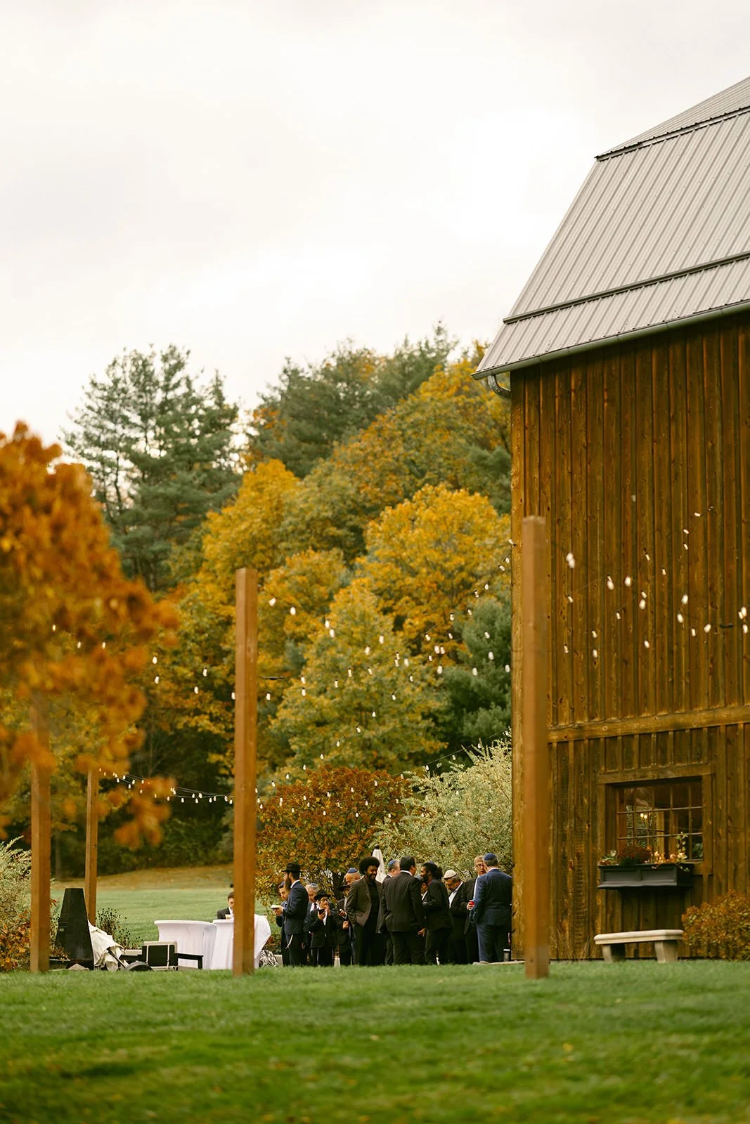 Distant view of the guests of the wedding celebrating on the patio of the venue. 
