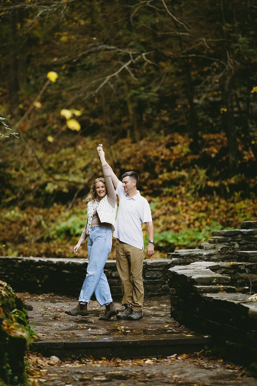 The future groom spins his future bride on the bridge together. 