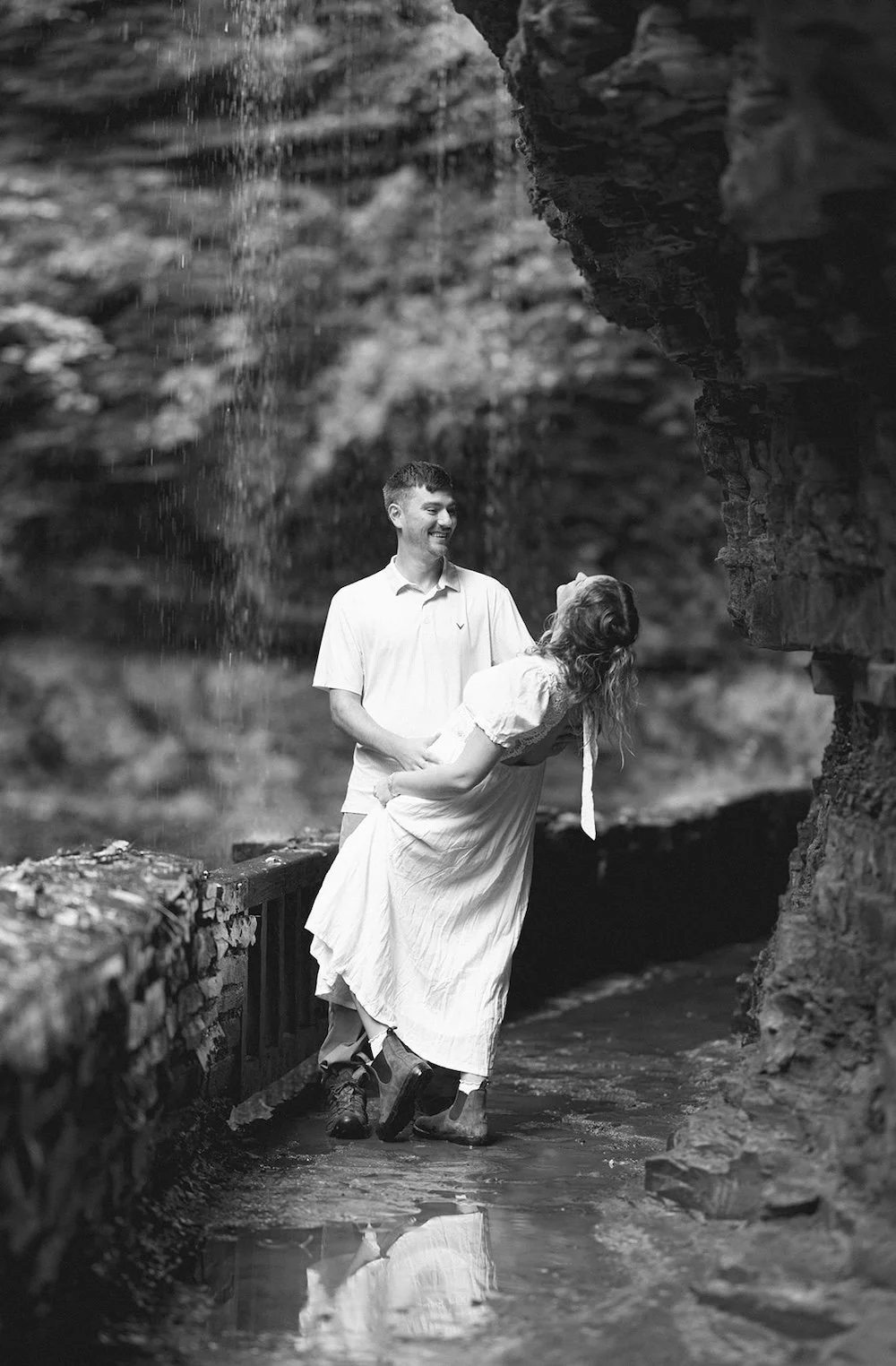 Black and white photo of the future groom dipping his bride to be. 