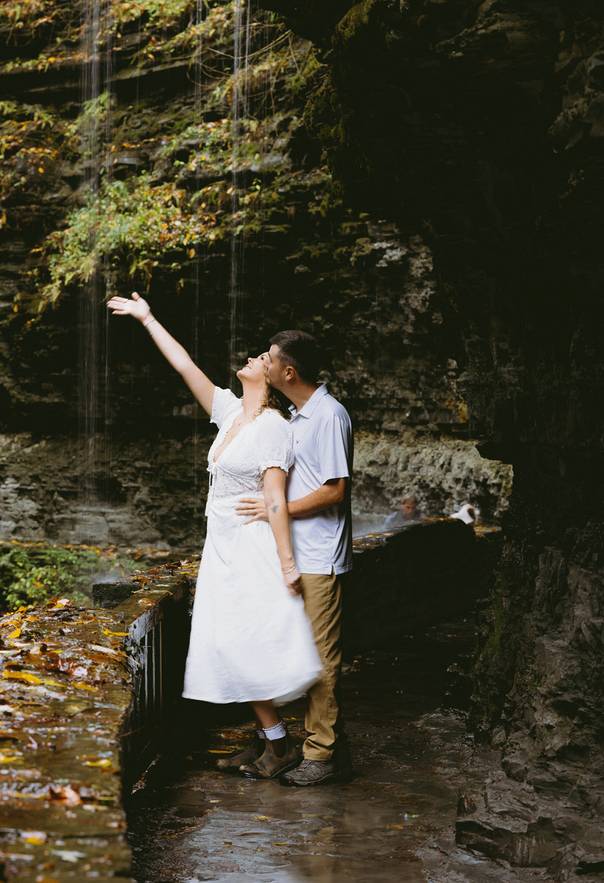 Live photo of the bride shaking her dress as she fells for the water to fall from the falls. 