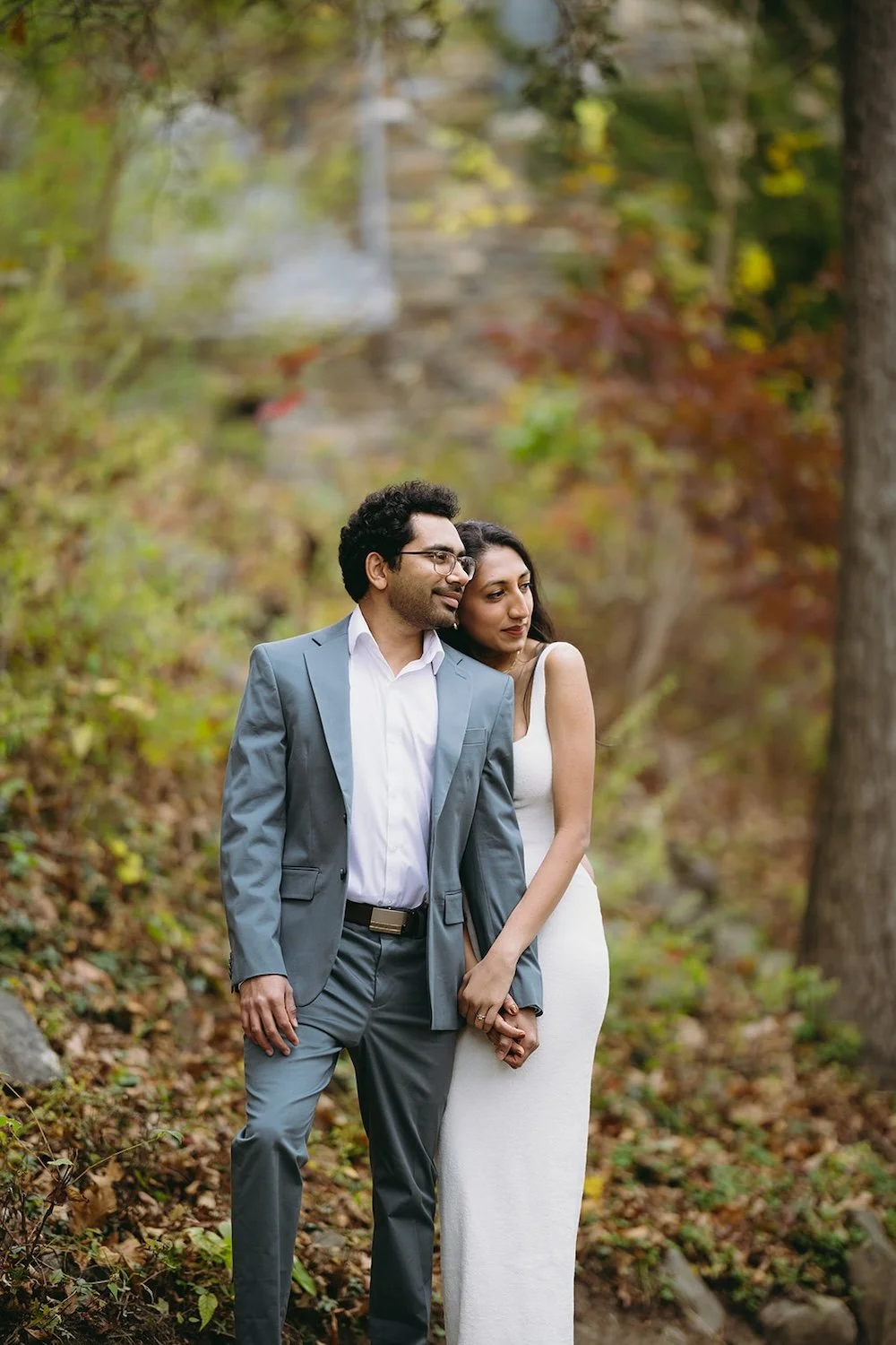 The future bride rests her head on her grooms shoulder as the admire their view. 