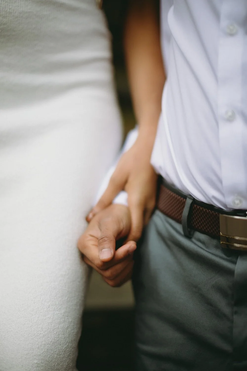 The bride to be holds her grooms hand close. 