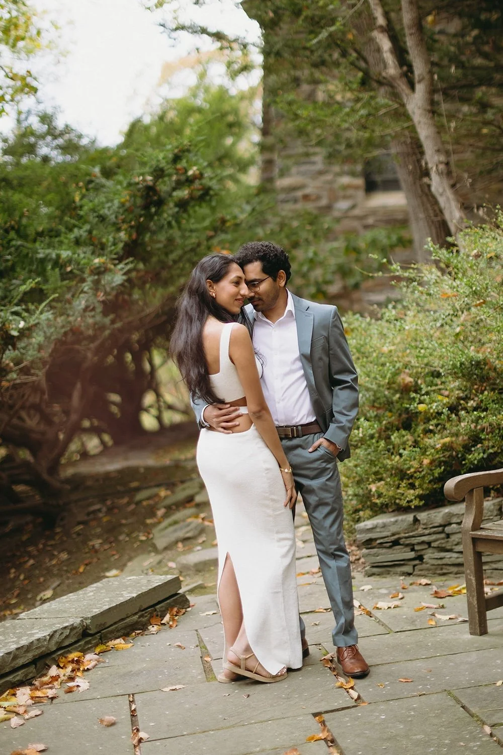 The future groom holds his future bride close as he nestles his head into her face. 