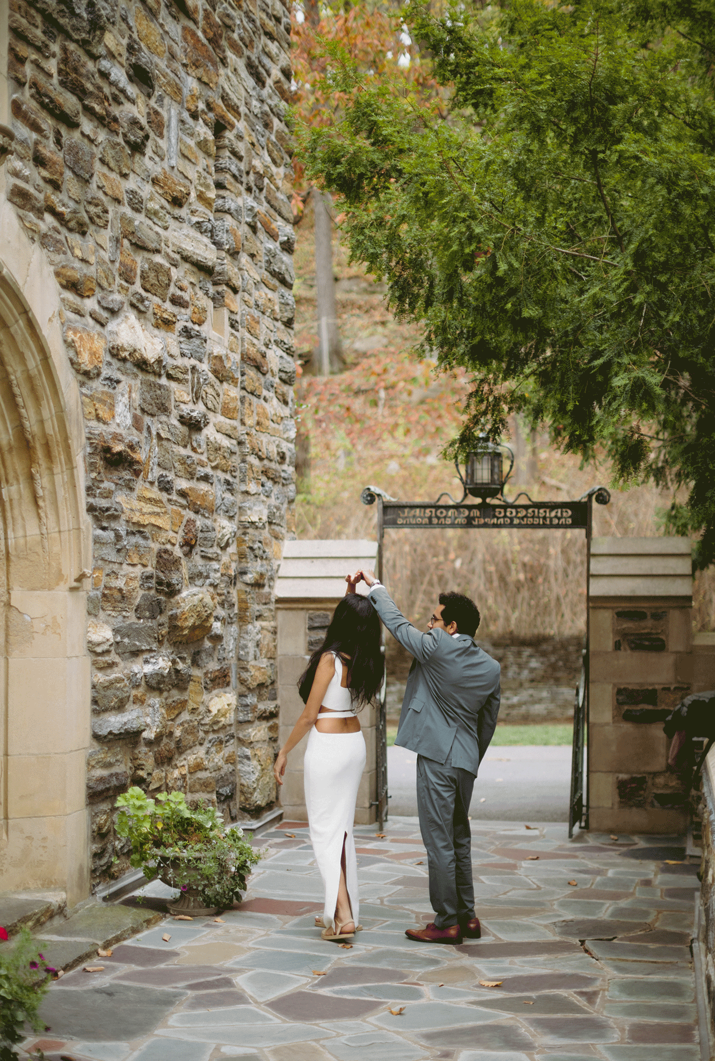 The future groom spins his bride in circles outside the church entry. 