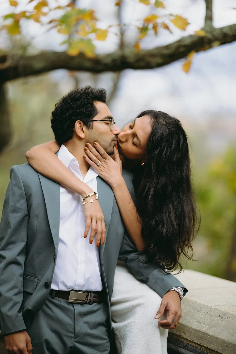 The future bride reaches in and kisses her groom to be. 