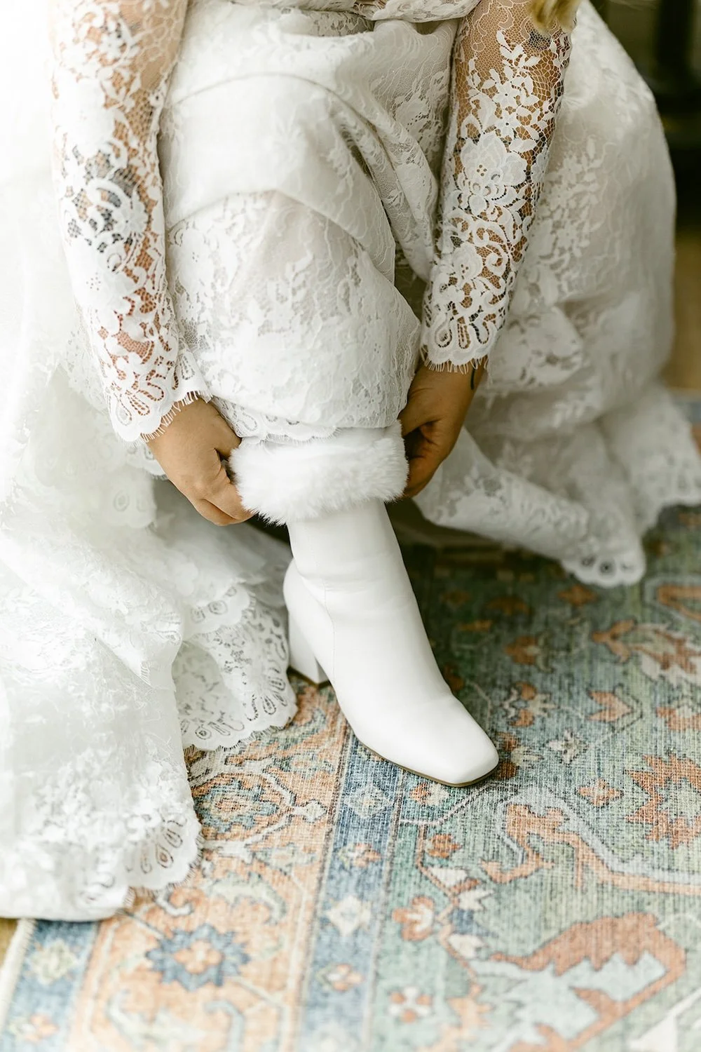 Detail photo of the bride putting her wedding shoes to complete her look.