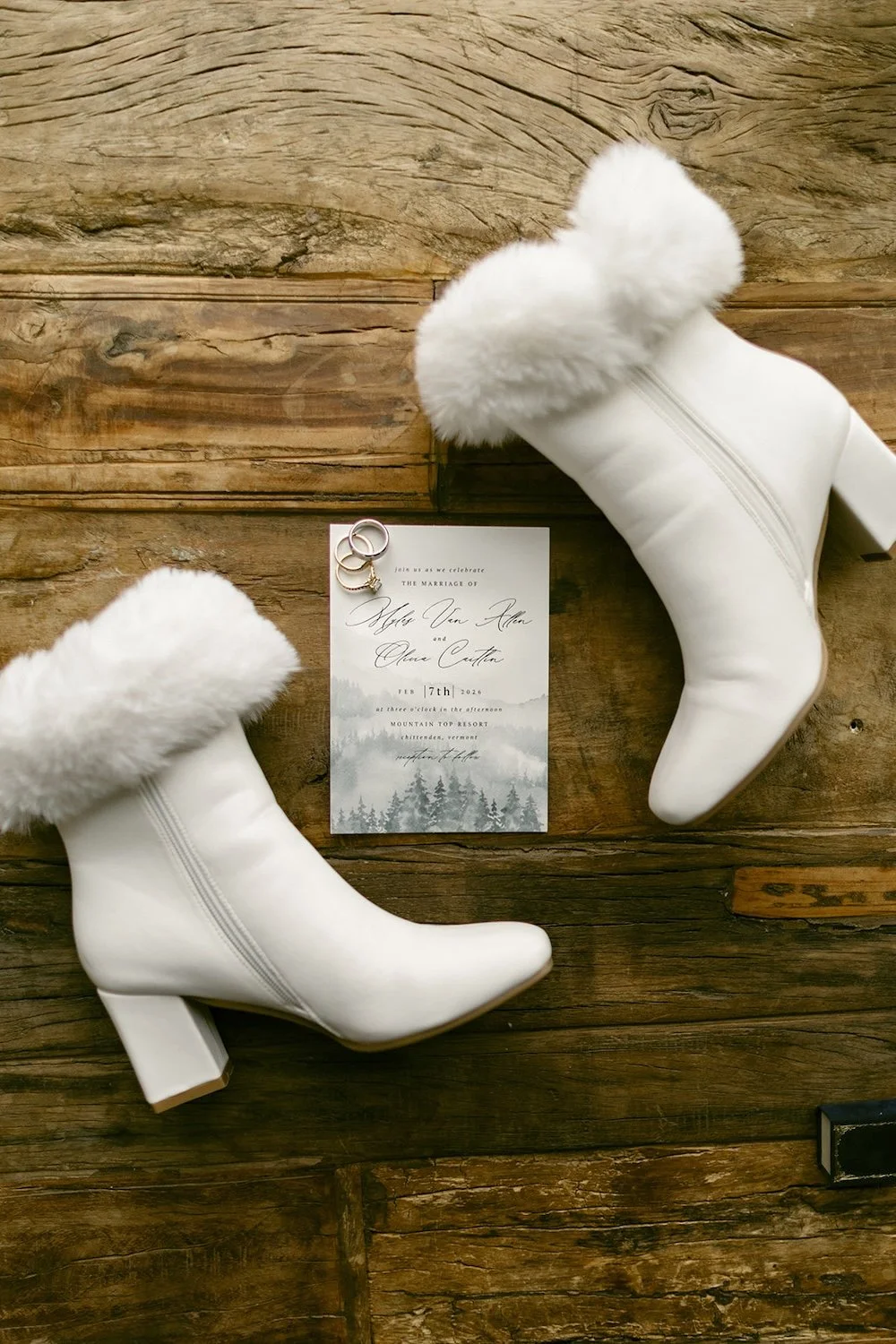 Detail photo of the brides wedding shoes with the wedding stationary.