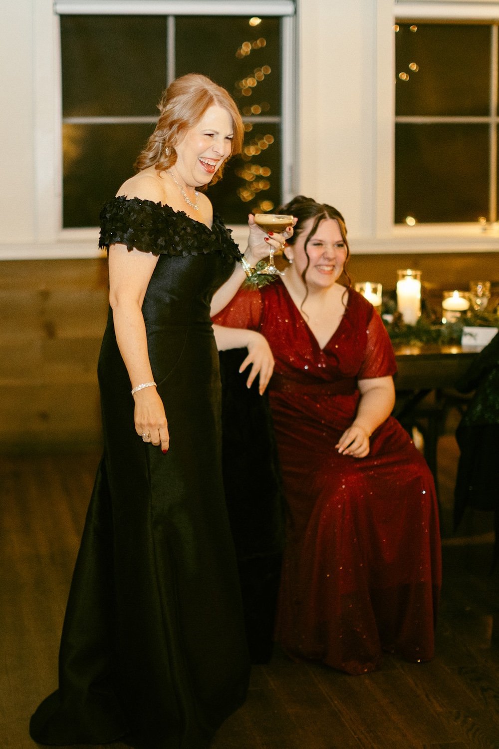Guests of the couple stand with smiles and laughter as they watch the couple. 