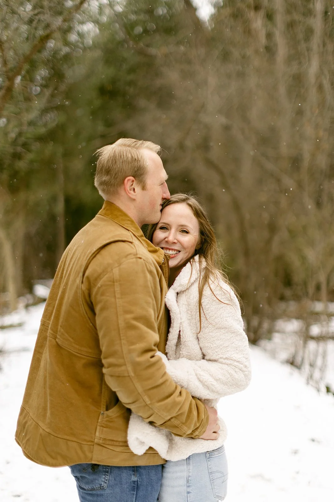 A couple takes winter engagement photos at Green Lakes State Park