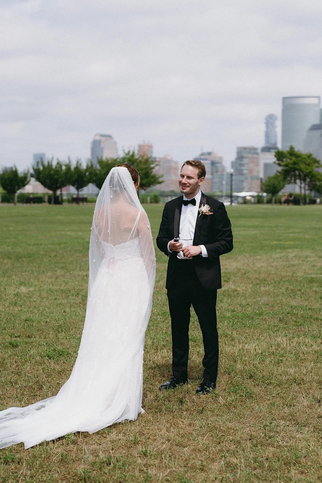 Romantic wedding first look with bride and groom sharing a private moment