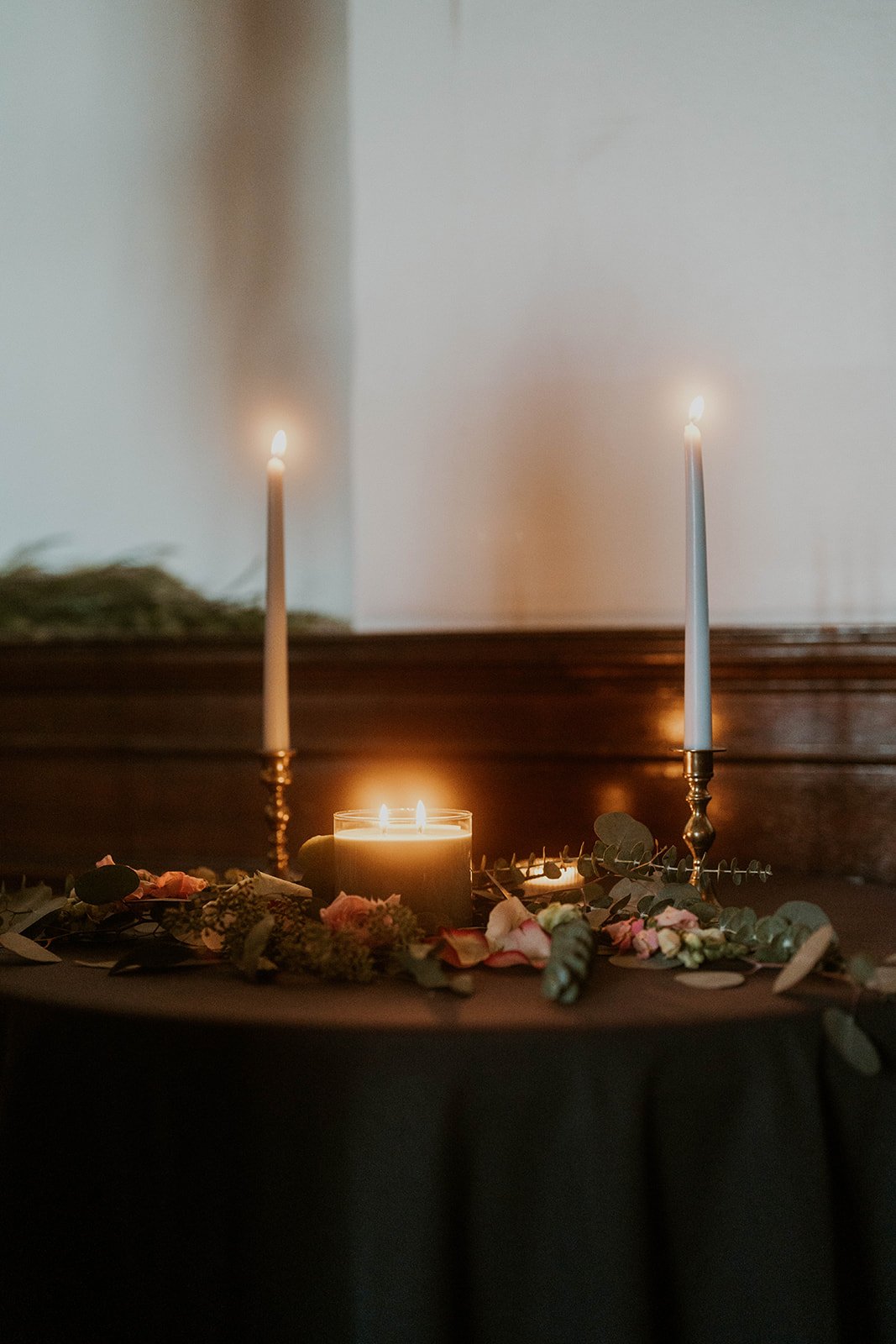 Bride and groom lighting a unity candle during their wedding ceremony, a meaningful Christian wedding ceremony idea.