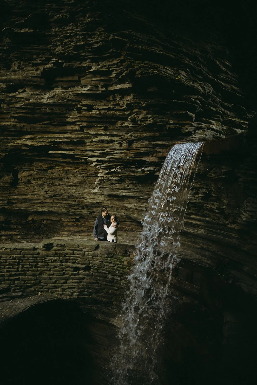 Couple overlooking a waterfall and rocky gorge at Watkins Glen State Park in Upstate New York