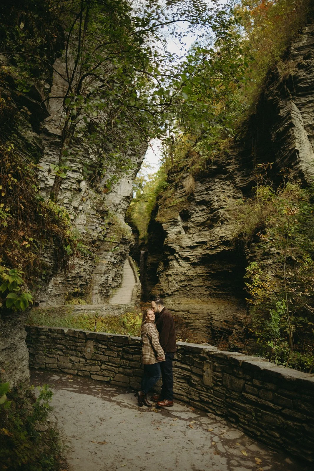 Couple overlooking a waterfall and rocky gorge at Watkins Glen State Park in Upstate New York