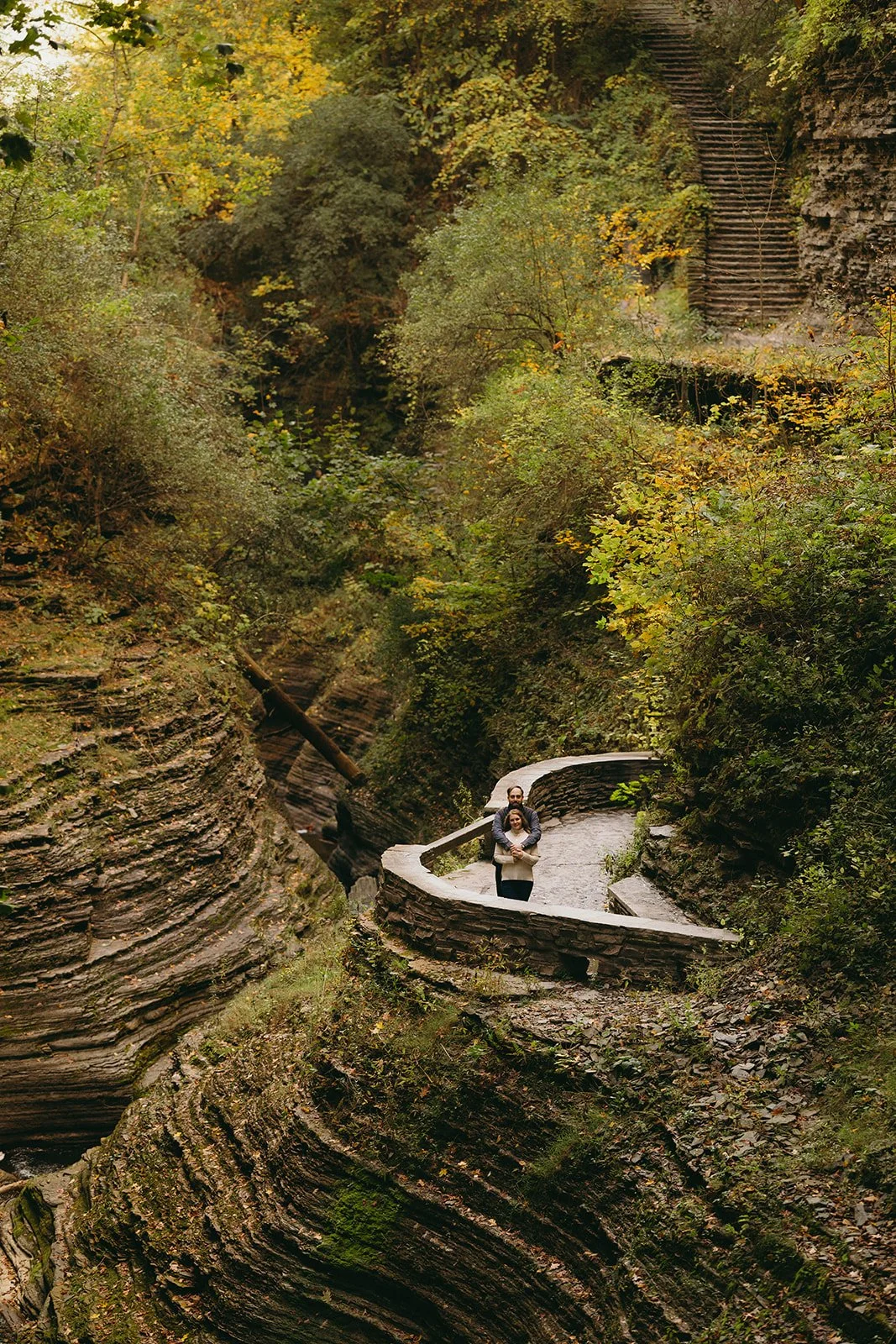Couple overlooking a waterfall and rocky gorge at Watkins Glen State Park in Upstate New York
