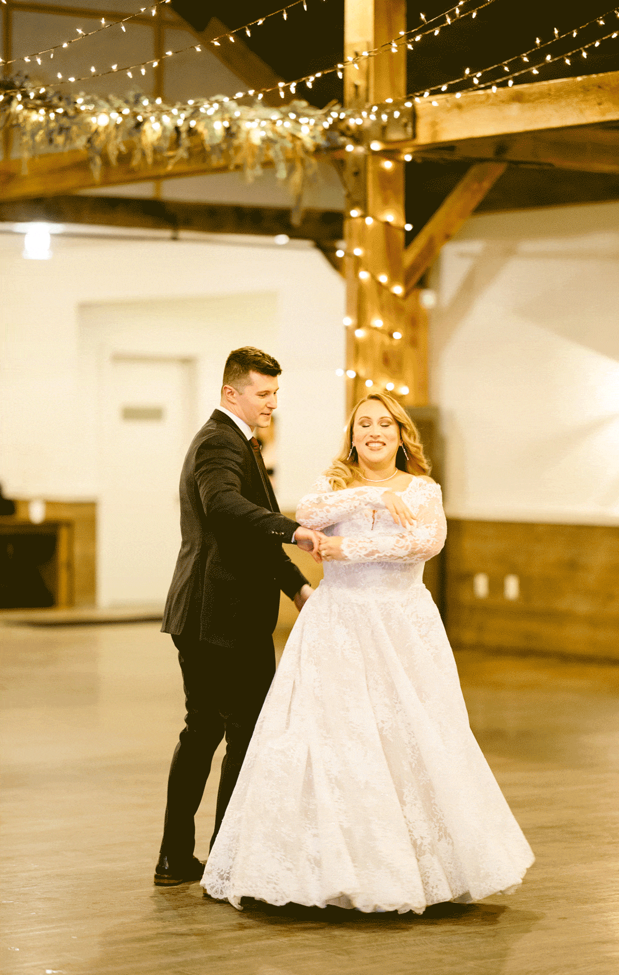 Live photo of the bride and groom sharing a dance together.