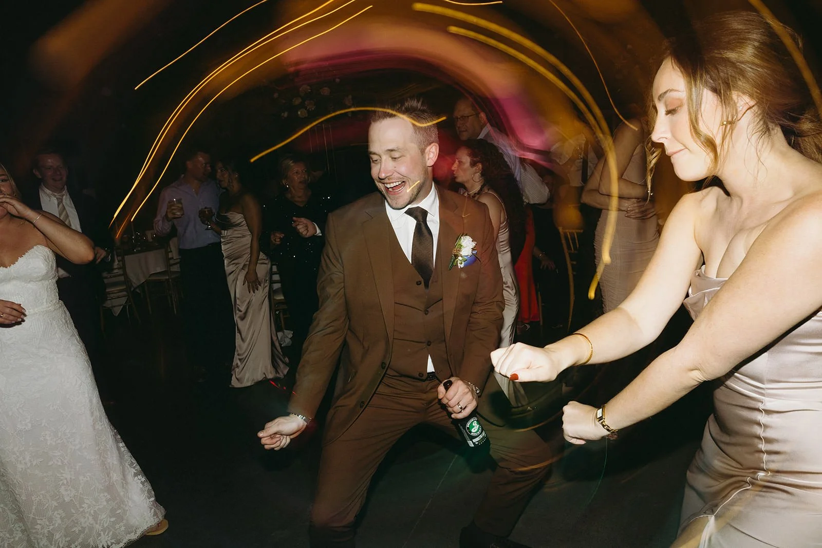 The groom dances with guests of the wedding.