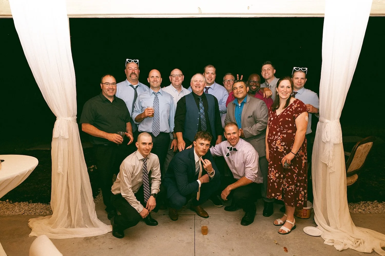 The groom and all of his fell colleagues pose for a photo together.