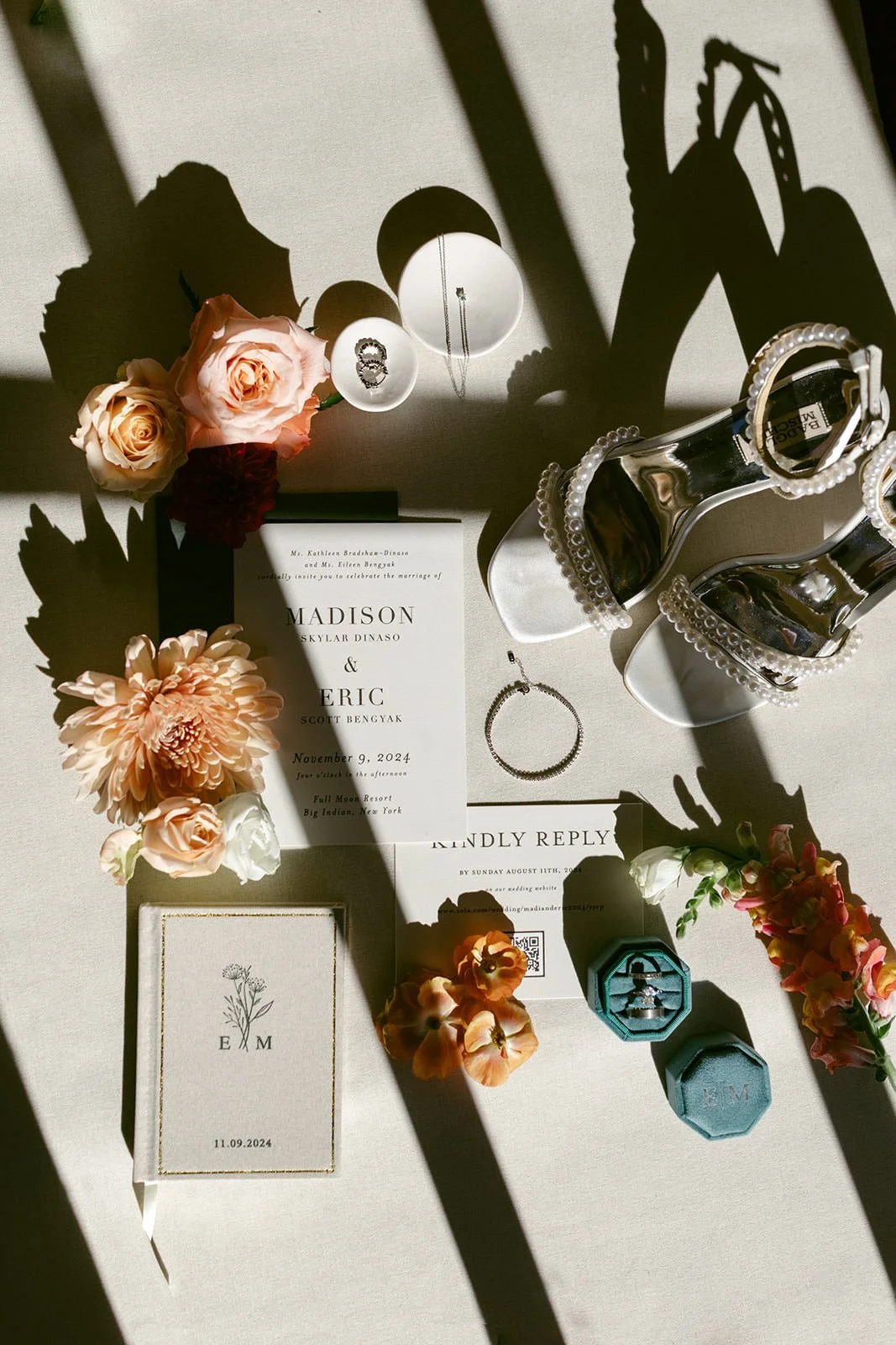 Detail photo of the wedding stationary, rings and the bridal florals.