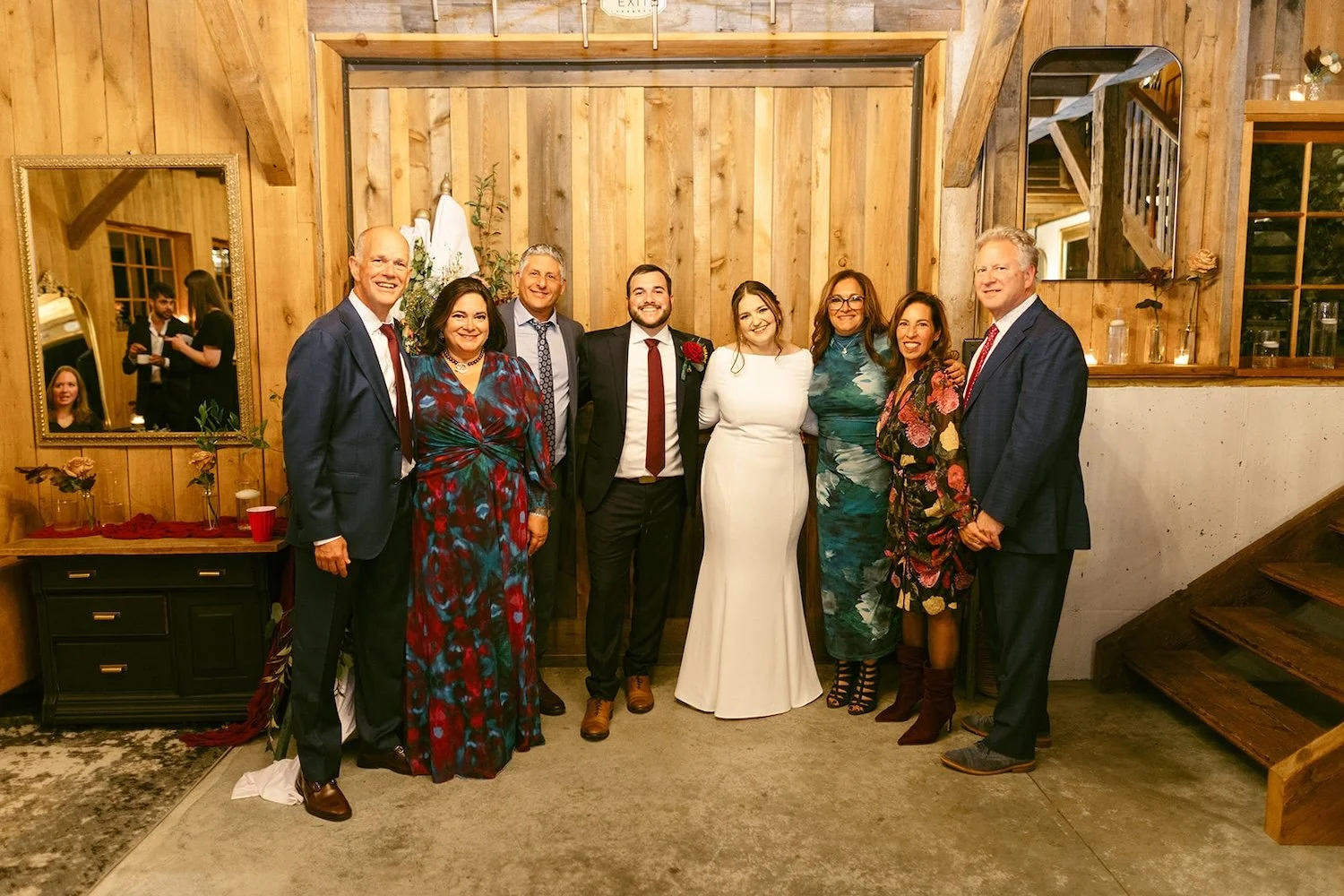 Family of the happy couple stand together posing.