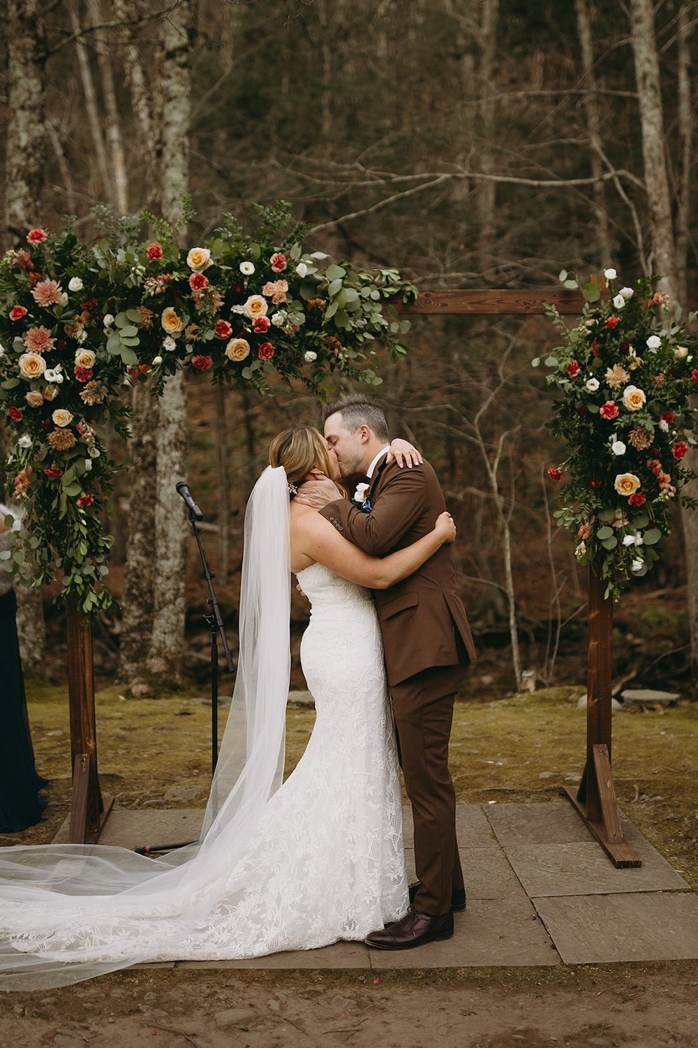 The newlyweds stand at the alter sharing their first kiss as Mr. and Mrs.