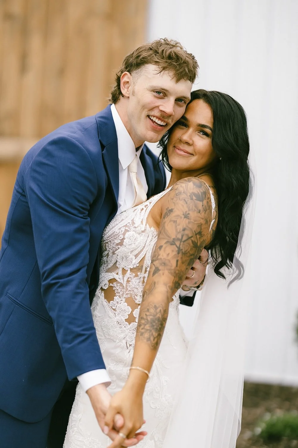 The bride and groom as they hold one another closely together.
