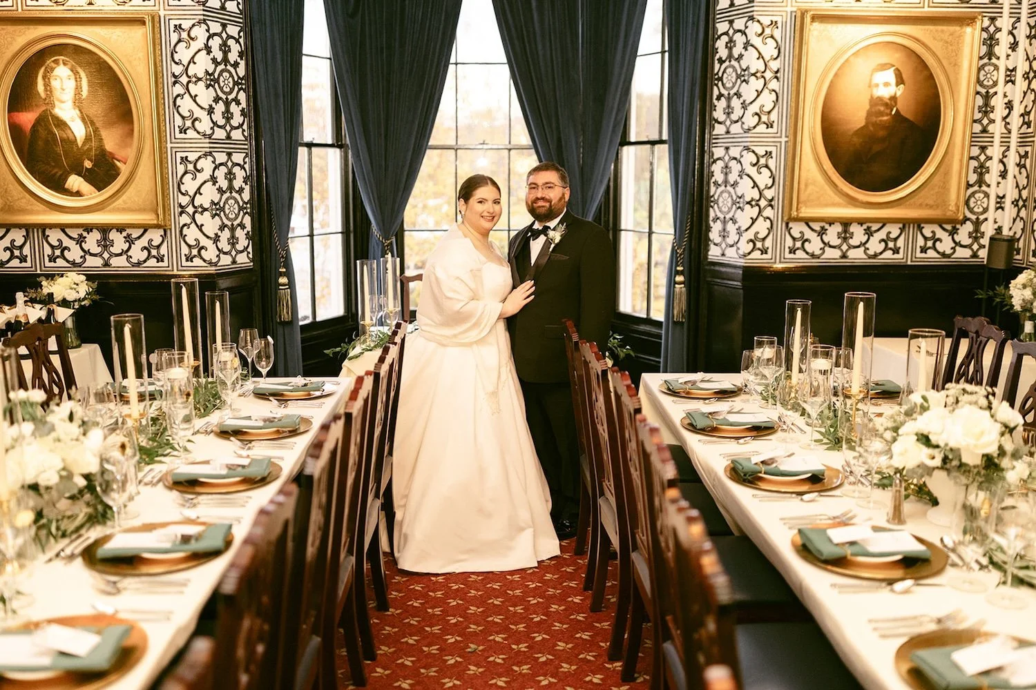 The bride and groom stand close to one another at the reception dinner.