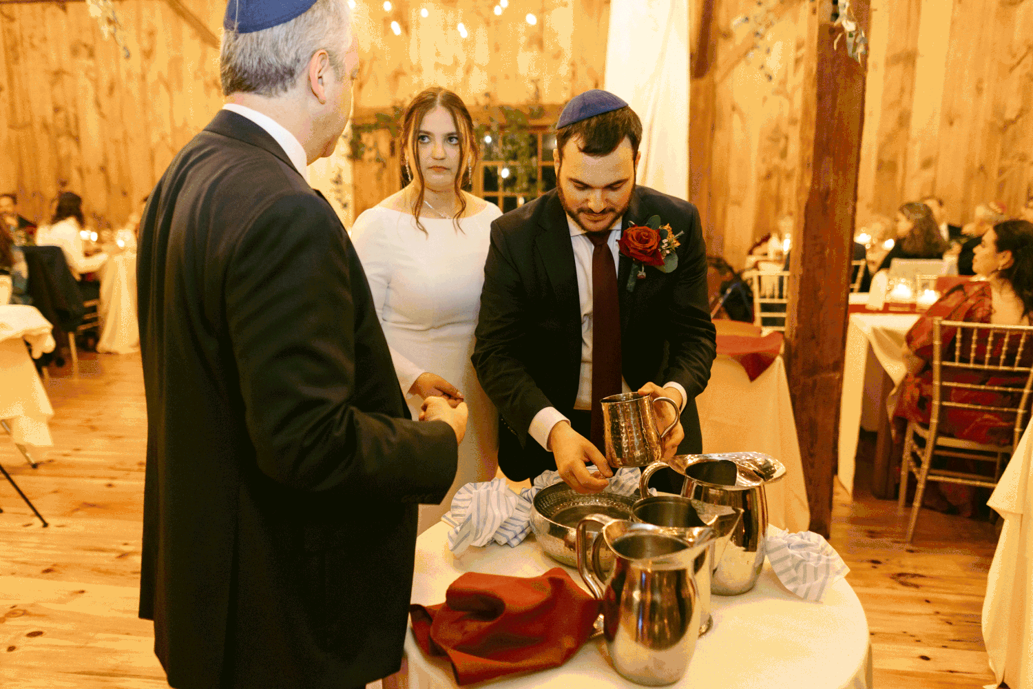 The couple perform the traditional washing of the hands before their wedding reception dinner.