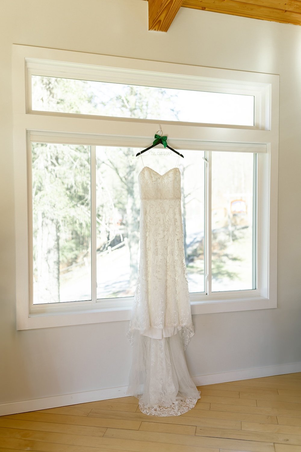 The wedding dress hangs from the window of the bridal suite.
