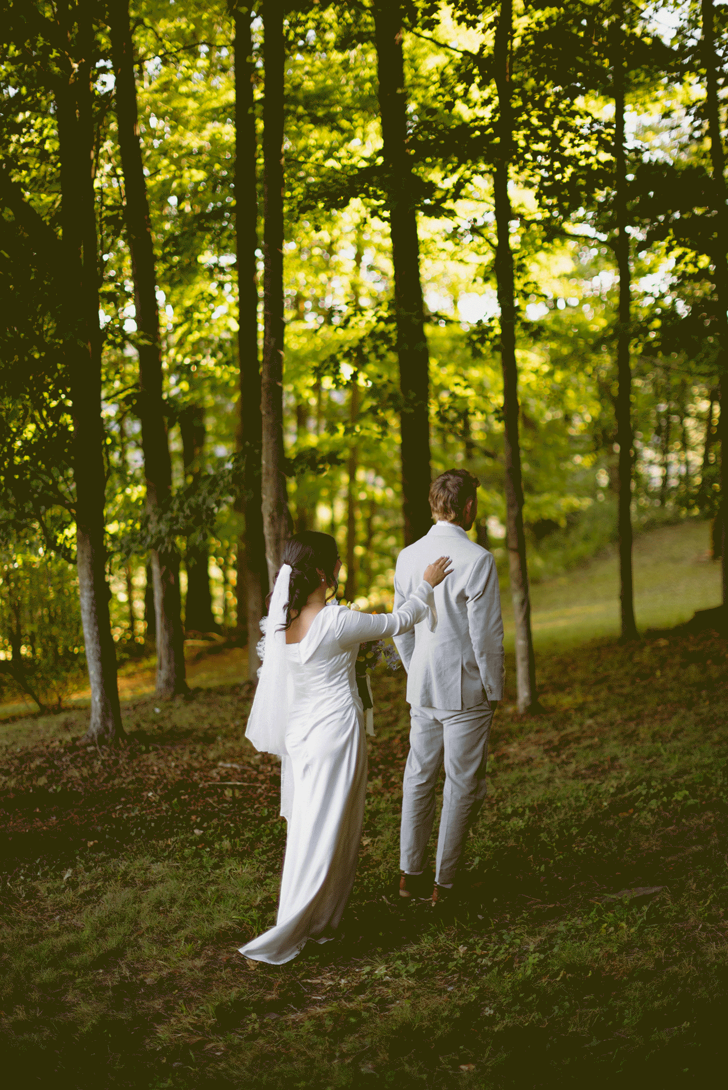 The bride taps the should of her groom while they share a moment for the first look.