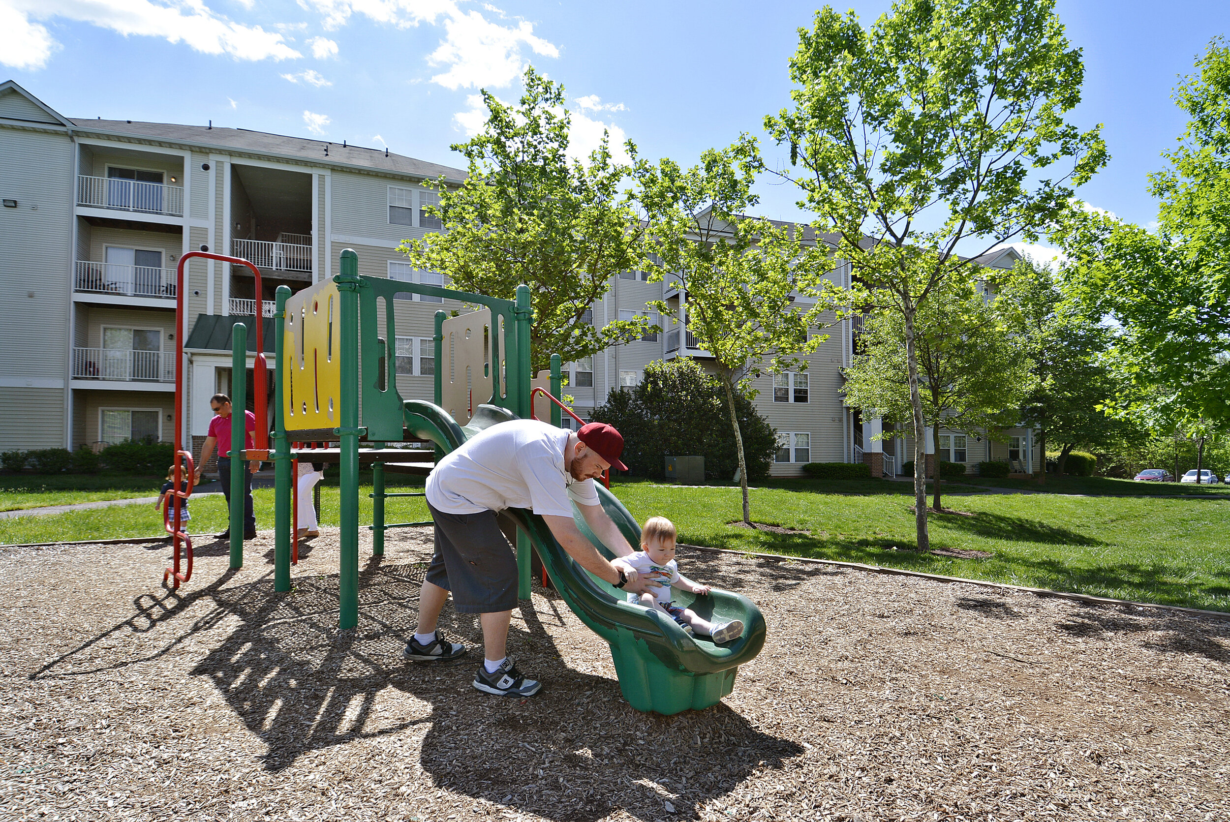  A family enjoying the community playground at Ashburn Meadows. 