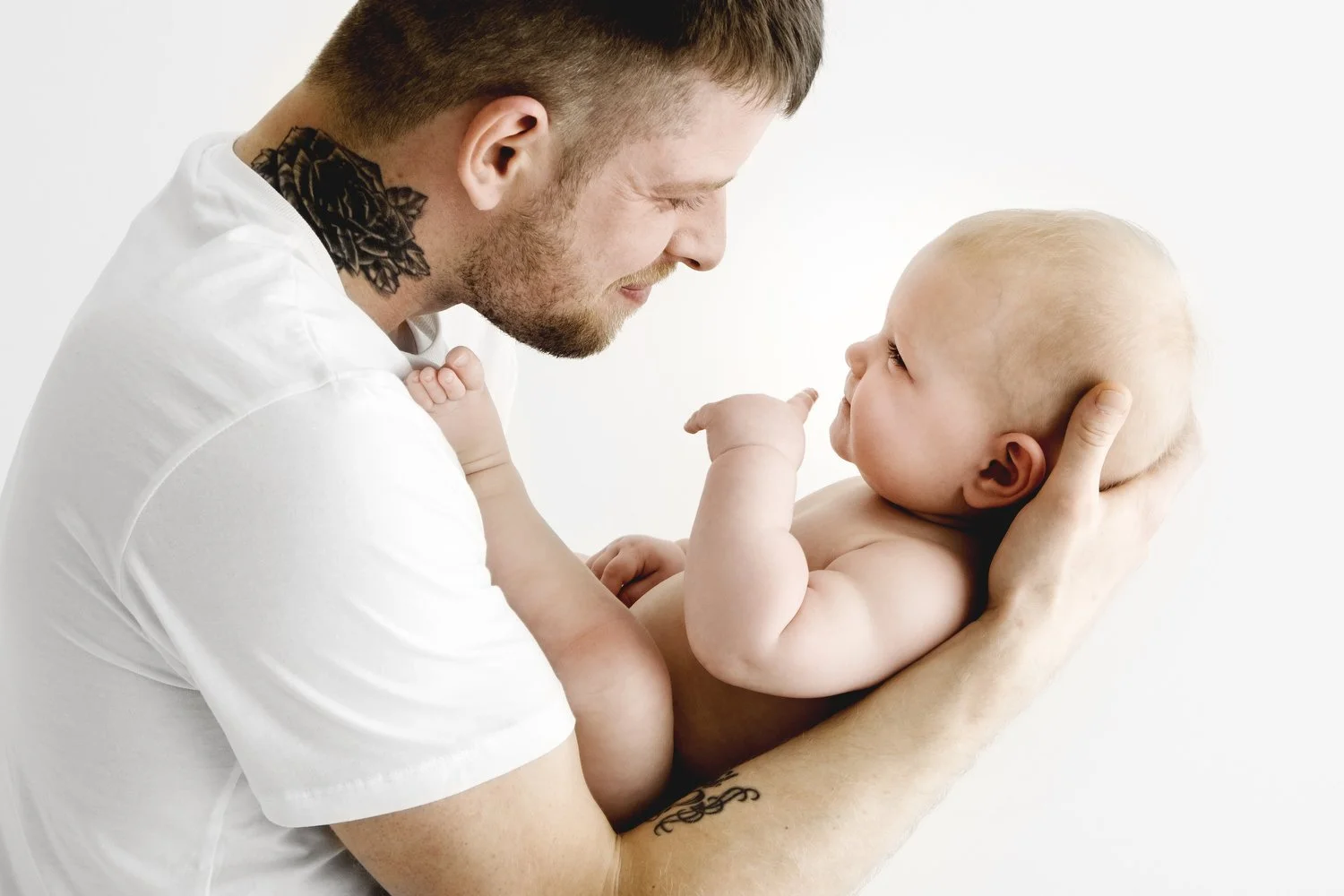 dad smiling at  9 month old baby at relaxed photography studio in dundee