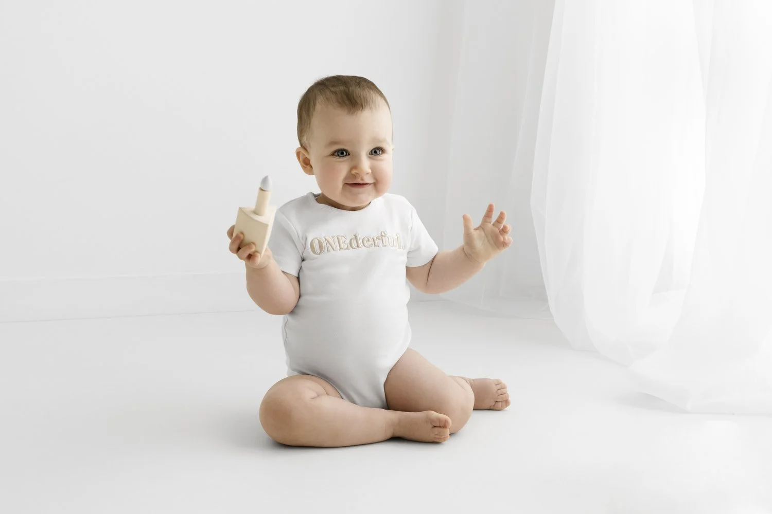 one year old baby at 1st birthday photoshoot in dundee onederful bodysuit in relaxed style