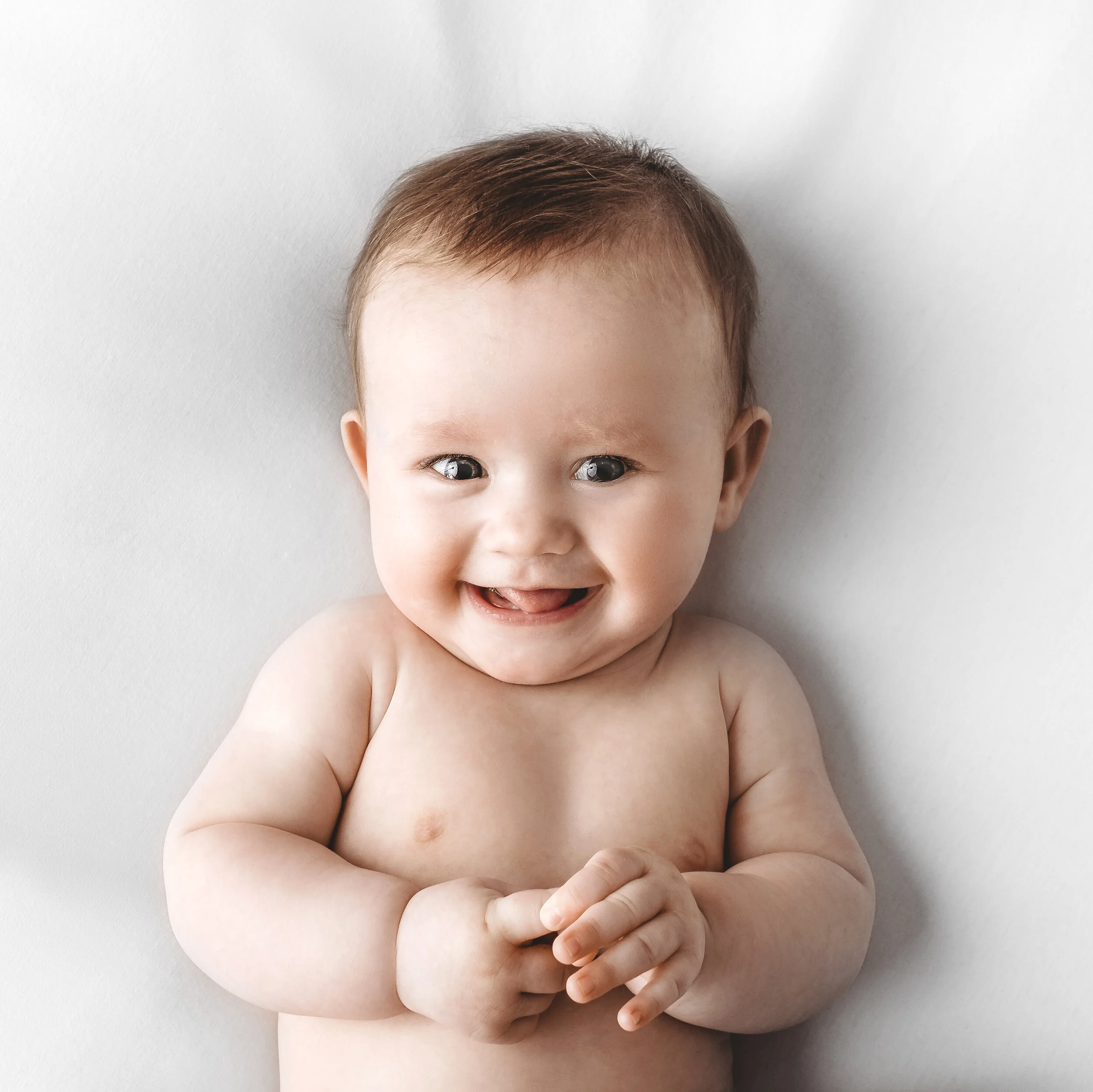 Smiling 4 month old baby during Dundee studio photoshoot