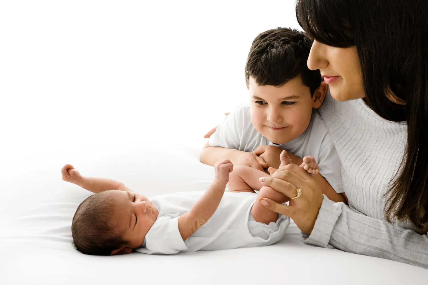 mum and son looking at newborn at Natural prop free newborn baby photography at Mabel and Moose studio Monifieth Dundee